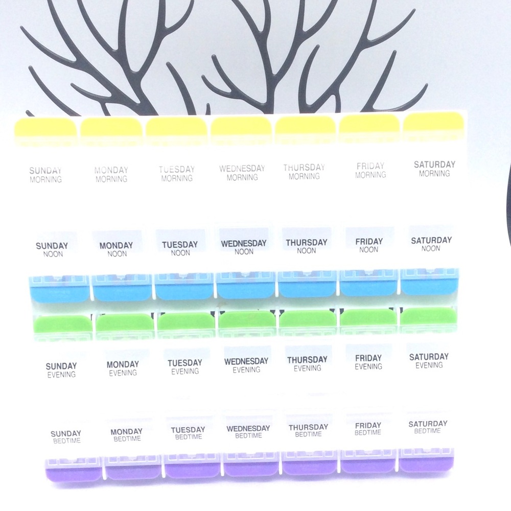 Weekly Pill Organizer with Colorful Lids. New